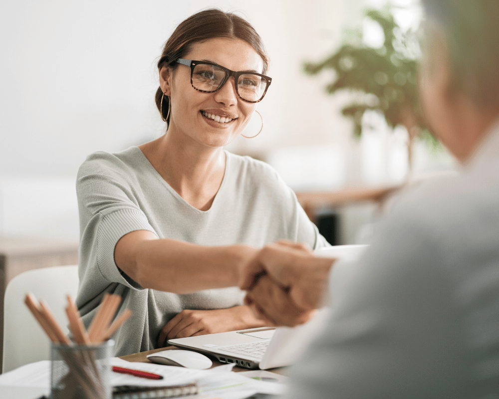 Woman shaking hands with colleague