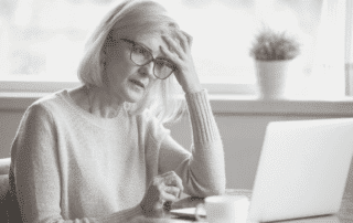 woman looking worried at laptop