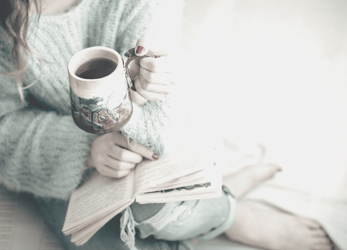 woman holding black coffee