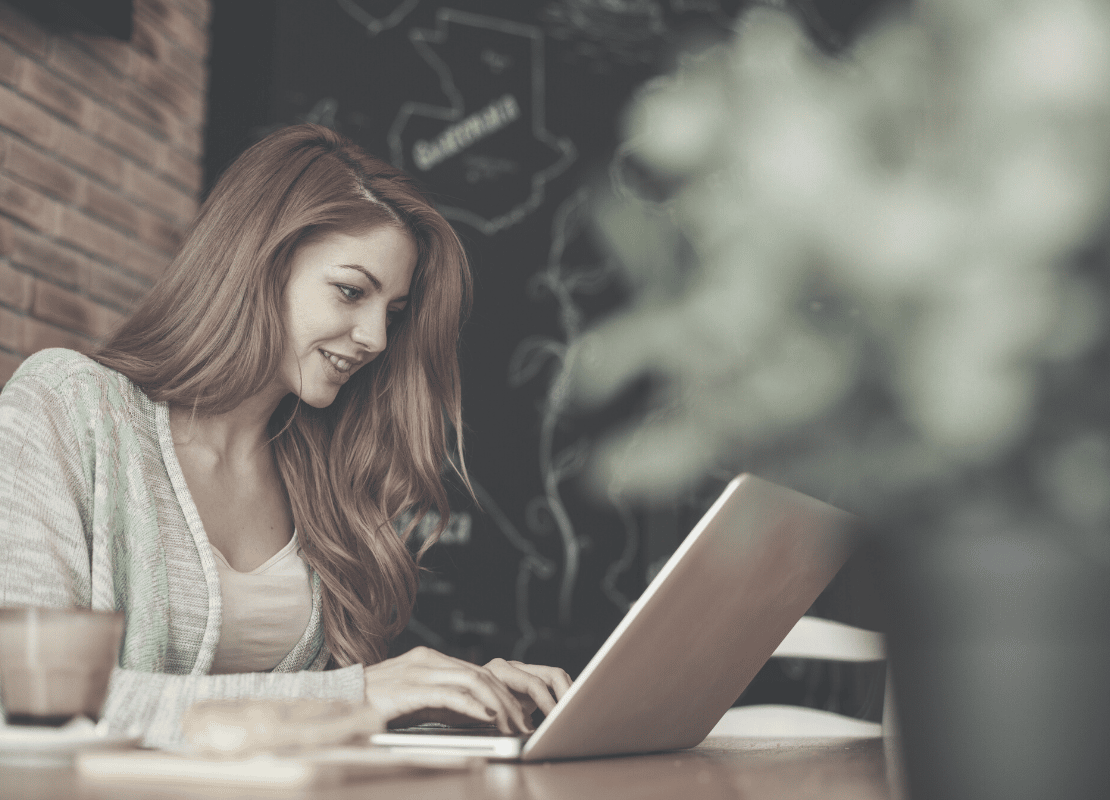 Developing your personal brand in a hybrid world. Woman working at laptop.