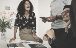 Woman laughing with colleagues. Building Influence in the Assistant Role