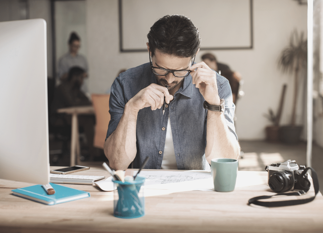 How to bring more focus into your work. Man at desk focused on work.