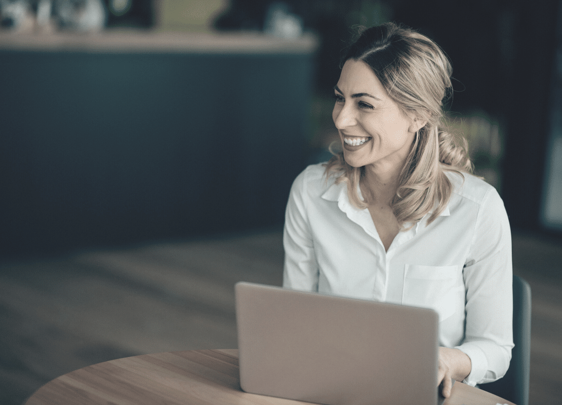 How do you demonstrate accountability in the workplace? Woman smiling at work.